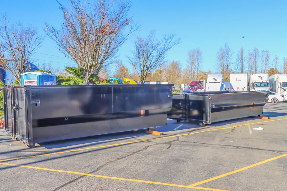 Professional dumpster rental service with roll-off container on residential driveway in Papillion